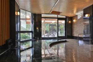 a lobby with a pool of water in a building at Grampus Sea in Shirahama