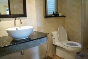 a bathroom with a sink and a toilet at Palita Lodge - SHA Plus in Haad Rin