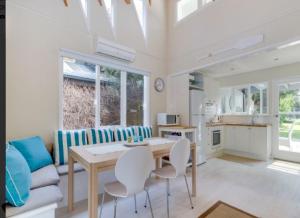 a kitchen and living room with a table and chairs at Beach House Getaway 1 in Smiths Beach