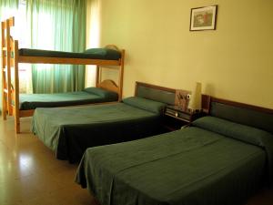 Posteľ alebo postele v izbe v ubytovaní Hotel Martinez