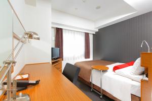 a hotel room with a bed and a desk with a desk at HOTEL MYSTAYS Kamata in Tokyo +25 photos