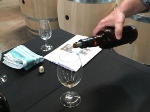 a person pouring a glass of wine on a table at bluebird cottage in Angaston +28 photos