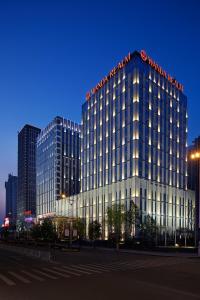a large building with a sign on top of it at Wanda Realm Huaian in Huai'an