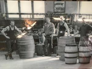a group of people standing in a kitchen with barrels at bluebird cottage in Angaston