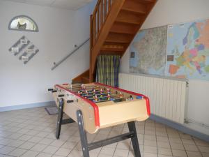 a foosball table in the corner of a room at Chambres d'hôtes La Ferme du Scardon in Neufmoulin