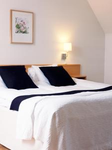 Ένα ή περισσότερα κρεβάτια σε δωμάτιο στο Hotel Kockska Gården