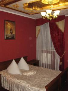 een slaapkamer met een bed met een gouden plafond bij Hotel Dubrava in Poltava