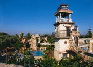 a resort with a swimming pool and a tower at Masseria Grande in Taurisano