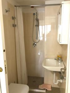 a bathroom with a shower and a sink at Casette sul Porto in Ischia +8 photos