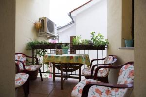 a balcony with a table and chairs in a room at Sonce in Izola