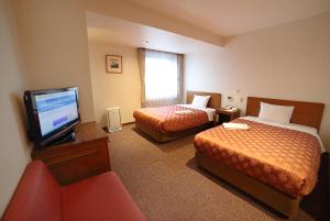 Postel nebo postele na pokoji v ubytování Kumegawa Wing Hotel + 37 fotografií
