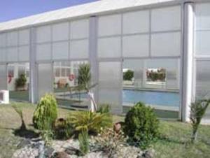 a large white building with plants in front of it at Urbanización Naturista Bahía de Vera in Vera