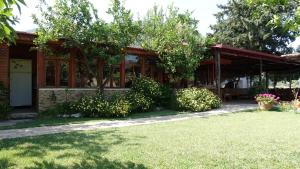 a house with a porch and a yard at Dalyan Pension in Dalyan
