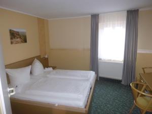 Postel nebo postele na pokoji v ubytování Hotel Wehlener Hof