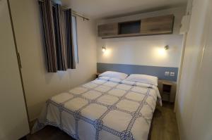 a hotel room with two beds and a television at Camping Village Torre Pendente in Pisa