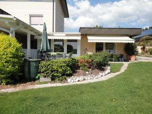 a house with a patio and a lawn at Ferienparadies Goritschnig in Velden am Wörthersee