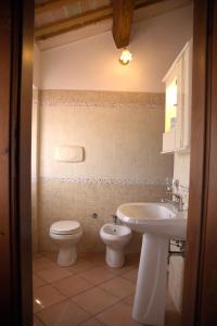 a bathroom with a toilet and a sink at L'Oasi di Pierino in Grottazzolina