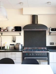 uma cozinha com uma placa de fogão e forno. em Hotel Ladeuze em Lovaina