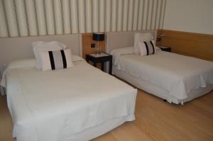 Кровать или кровати в номере Gran Hotel Sardinero