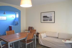 a living room with a table and a couch at Ariston in Lignano Sabbiadoro