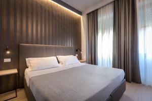 A bed or beds in a room at Blu Notte Guest House