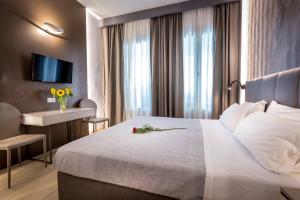 A bed or beds in a room at Blu Notte Guest House