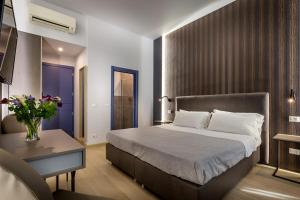 A bed or beds in a room at Blu Notte Guest House