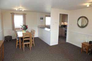 a kitchen and dining room with a table and chairs at Castleyards Apartment 2 in Kirkwall