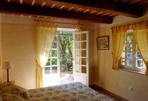 a bedroom with a bed and a sliding glass door at Le Bastidon Saint-Michel in Sainte-Maxime