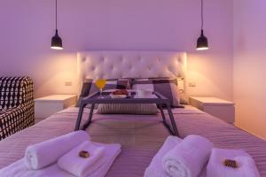a bed with a tray of food and a table on it at Monte & Paradiso in Pula