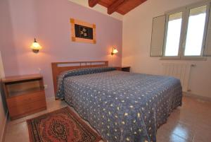 a bedroom with a bed and a dresser and a window at Agriturismo Montalbano in Cartabubbo