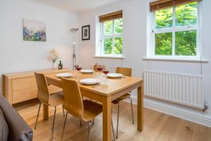 a dining room with a wooden table and chairs at Sunny 2BR apt in the heart of Vauxhall, by subway in London