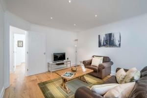 a living room with a couch and a coffee table at Sunny 2BR apt in the heart of Vauxhall, by subway in London