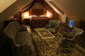 1 dormitorio con 1 cama, mesa y sillas en Hotel Princess, en Lednice