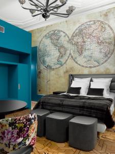 a bedroom with a large bed with a large map on the wall at Le Moon in Strasbourg