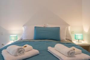 a bed with towels and pillows on it at Monte & Paradiso in Pula