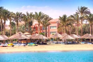 a resort with a beach with umbrellas and palm trees at Kefi Palmera Beach Resort El Sokhna - Family Only in Ain Sokhna