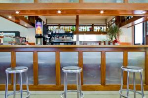 a bar with three stools in front of it at Hotel Ibiltze in Lasarte