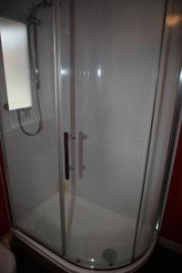 a shower with a glass door in a bathroom at Castleyards Apartment 1 in Kirkwall