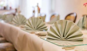 a table with plates and napkins on top at Hotel Thielmann in Mittenaar