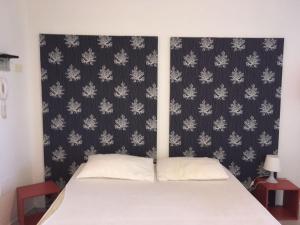 a bedroom with a bed with a black and white wallpaper at Mono Corso Italia in Sirolo