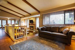 a living room with a couch and a fireplace at Coles Bay Vacation Retreat in North Saanich