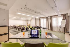 a conference room with chairs and a laptop on a table at Warmthotel in Rome