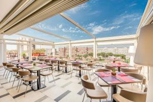 a restaurant with tables and chairs and a view of the city at Warmthotel in Rome
