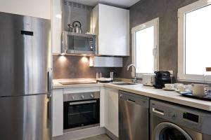 a kitchen with a stainless steel refrigerator and stove at Picasso Premium in Málaga