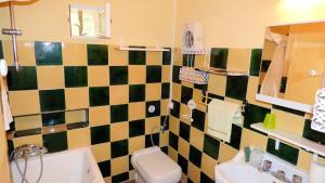 a bathroom with a black and white tiled wall at L'Estagnol in Le Castellet