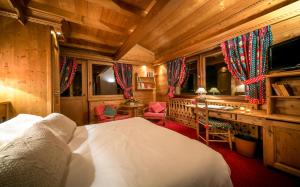a bedroom with a bed and a desk in a room at Hotel & Spa Le Dahu in Morzine +34 photos