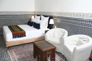 سرير أو أسرّة في غرفة في Riad Batchisarai