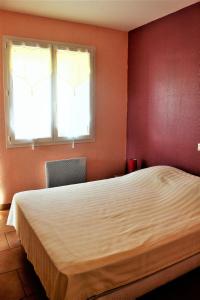 a bedroom with a large bed and two windows at LOCATIONS RIVES DE SEUGNE - Claveau in Jonzac