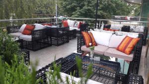 un patio con sofás y almohadas en un balcón en Aria Hotel Chisinau, en Chişinău